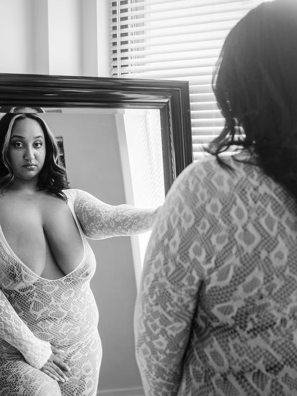 High-contrast black and white boudoir pose